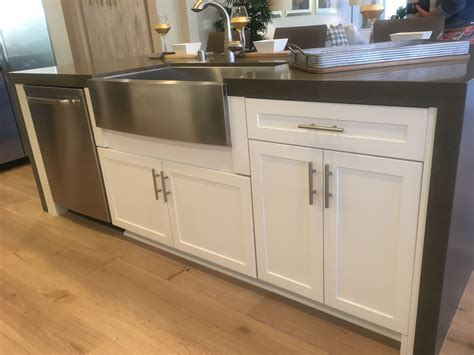 white appliances and stainless steel apron sink with stained cabinets|white apron front farm sink.